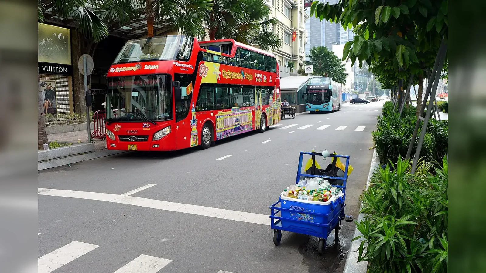 Red open-top sightseeing bus on Le Loi Boulevard